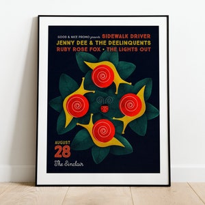 May include: A framed poster with a dark blue background features a colorful illustration of snails and leaves. The poster promotes a concert with the text "SIDEWALK DRIVER" and "JENNY DEE & THE DEELINQUENTS". The date "AUGUST 28" is also displayed.