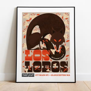 May include: A poster advertising a concert by Los Lobos at The Cut in Gloucester, MA on October 9, 2024. The poster features a stylized illustration of a wolf in brown and red colors against a background of white flowers.