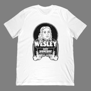 May include: White t-shirt with a black and white graphic. The design features a portrait of a person inside a circle, with the name "WESLEY" above the text "IS MY HOMEBOY". Hands are holding the text.