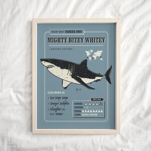 May include: A blue and white illustrated poster with the text "Know Your DANGER BOIS MIGHTY BITEY WHITEY (KILLIUS GILLIUS)". The poster features a cartoon illustration of a great white shark with the text "ALSO KNOWN AS: Sea Nope Nope, Danger Dolphin, Slaughter in the Water" and "FACT FILE: DANGER: AAAAA, FRIENDS: <2, TEETH: AAAAAAAA, LIKES: SKINNY DIPPING".