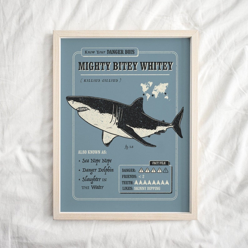 May include: A blue and white illustrated poster with the text "Know Your DANGER BOIS MIGHTY BITEY WHITEY (KILLIUS GILLIUS)". The poster features a cartoon illustration of a great white shark with the text "ALSO KNOWN AS: Sea Nope Nope, Danger Dolphin, Slaughter in the Water" and "FACT FILE: DANGER: AAAAA, FRIENDS: <2, TEETH: AAAAAAAA, LIKES: SKINNY DIPPING".