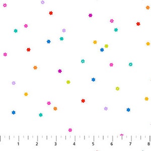 May include: White fabric with a scattered pattern of colorful, five-pointed stars. The stars are in various shades including red, orange, yellow, green, blue, purple, and pink. The fabric has a ruler printed along the bottom edge.