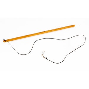 May include: A wooden stick with a black string attached to one end and a silver chain with a clip attached to the other end.