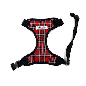 May include: Red and black tartan dog harness with a black adjustable strap and a label that reads "Barkley & Fitch Canine Outfitters".
