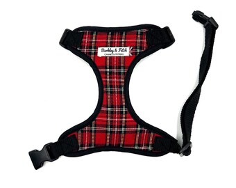 May include: Red and black plaid dog harness with a black adjustable strap and a label that reads "Barkley & Fitch Canine Outfitters".