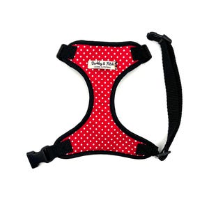 May include: Red dog harness with white polka dots and black adjustable straps. The harness has a black label that reads "Barkley & Fetch Canine Outfitters".