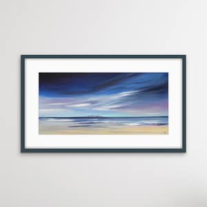 May include: A framed painting depicting a seascape with a blue sky, white clouds, and a distant island. The water is a light blue and the sand is a light yellow.