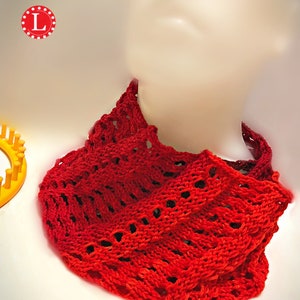 May include: Red crocheted cowl with a lacy pattern. The cowl is worn on a mannequin.