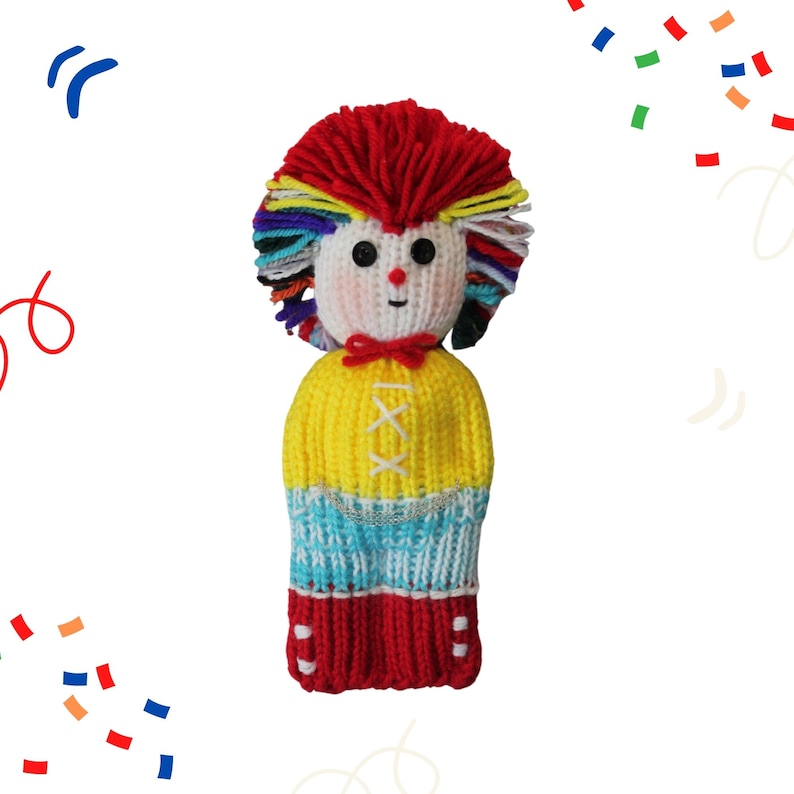 May include: A colorful knitted doll with a red, yellow, blue, and white striped outfit. The doll has a red yarn pom-pom for hair and a white face with black button eyes.