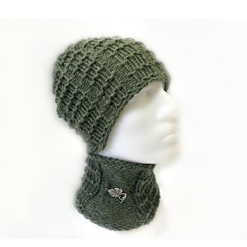 May include: A green knitted hat and matching neck warmer set. The hat has a diamond pattern and the neck warmer has a leaf design.