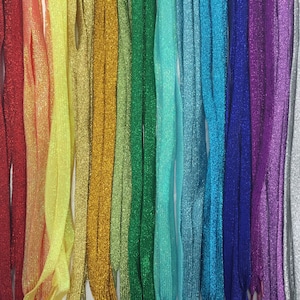 May include: Assortment of colorful sparkly shoelaces in various colors, including pink, red, yellow, gold, green, blue, purple, silver, and black.