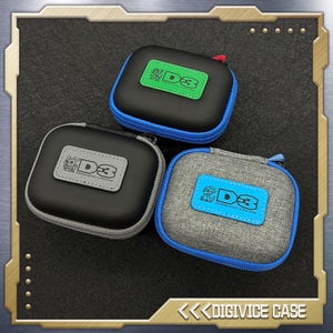 May include: Three square, zippered cases in black, gray, and patterned gray fabric. Each case has a colored patch with the text "D3" and a cartoon character. The cases have blue or gray trim and zippers. The cases are labeled "DIGIVICE CASE".