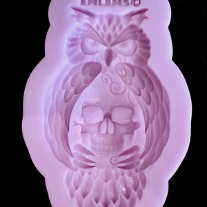 May include: Purple silicone mold with a detailed design of an owl with a skull inside. The mold is labeled "ENLEMSO".