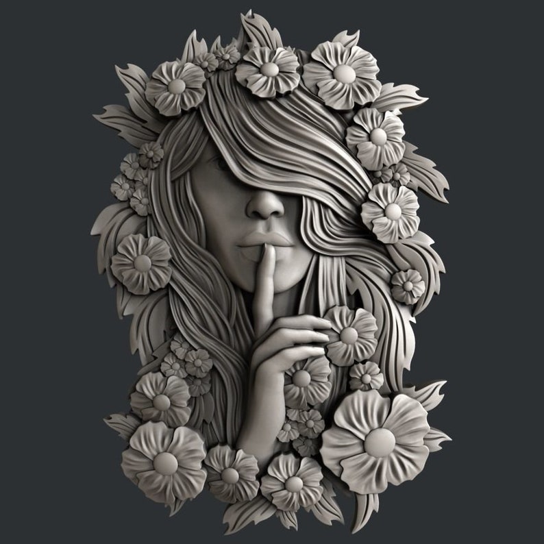 May include: A 3D relief sculpture of a woman's face with her hair flowing around her. She is surrounded by flowers and leaves. Her finger is on her lips, as if she is asking for silence.