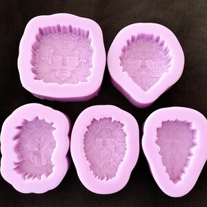 May include: Five purple silicone molds for making resin crafts. Each mold features a different design of a face with intricate details.