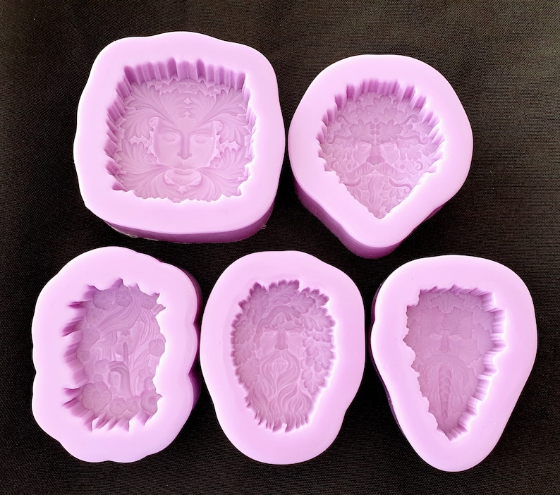 May include: Five purple silicone molds for making resin crafts. Each mold features a different design of a face with intricate details.