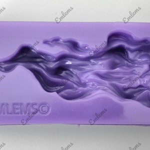 May include: Purple silicone mold with a raised design of a flame. The mold has the word "EMLEMSO" embossed on the bottom.