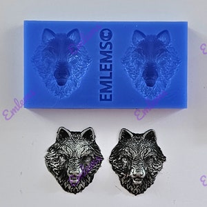 May include: Two silicone molds for making wolf head shapes. The molds are blue and have the word "EMILMSO" printed on them. Two silver wolf head shapes are shown below the molds.