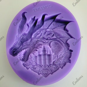 May include: Purple silicone mold with a detailed design of a dragon's head and wings, a castle, and ornate details. The mold is labeled "EMILMSO".