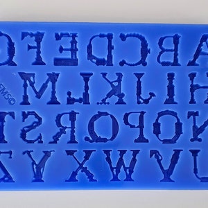 May include: Blue silicone alphabet mold with uppercase letters A through Z. The letters are in a vintage style font.