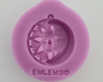 May include: Purple silicone mold with a design of a sun and moon with a face in the center. The mold has the word "EMLEMSO" printed on the bottom.