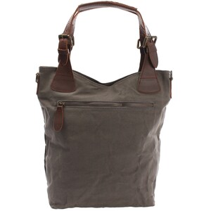 May include: A gray canvas tote bag with brown leather handles and buckles. The bag has a zippered pocket on the front.