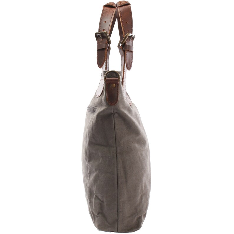 May include: A gray canvas tote bag with brown leather handles and buckles. The bag has a zippered pocket on the front.