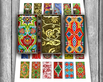 May include: A collection of rectangular pendants with ornate, colorful patterns. The pendants feature floral and geometric designs in red, green, blue, and gold, set in silver-toned frames. The pendants are arranged on a white surface.