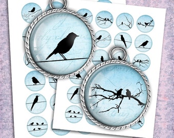 May include: Two silver charm pendants with blue glass inserts. One pendant features a single black bird silhouette on a wire, the other features three black birds on a branch. Both pendants have a distressed, vintage look.