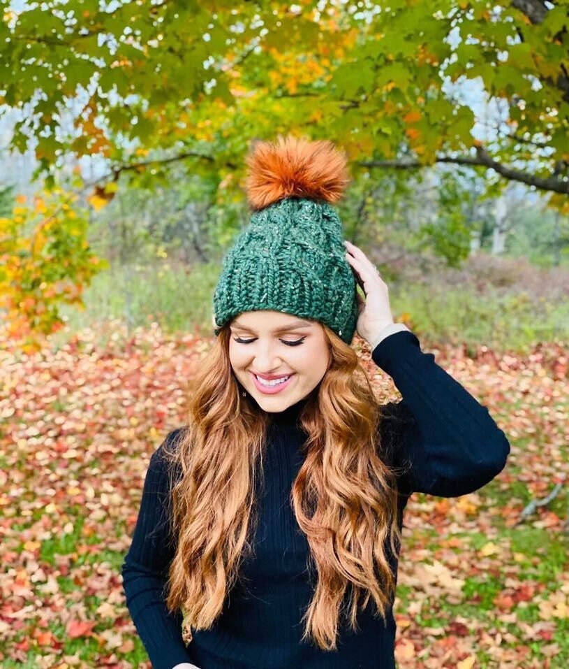 cable knit beanie with faux fur pom
