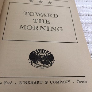 May include: A book cover with the title "Toward the Morning" by Hervey Allen. The cover features a black and white illustration of a sunrise over a mountain range.