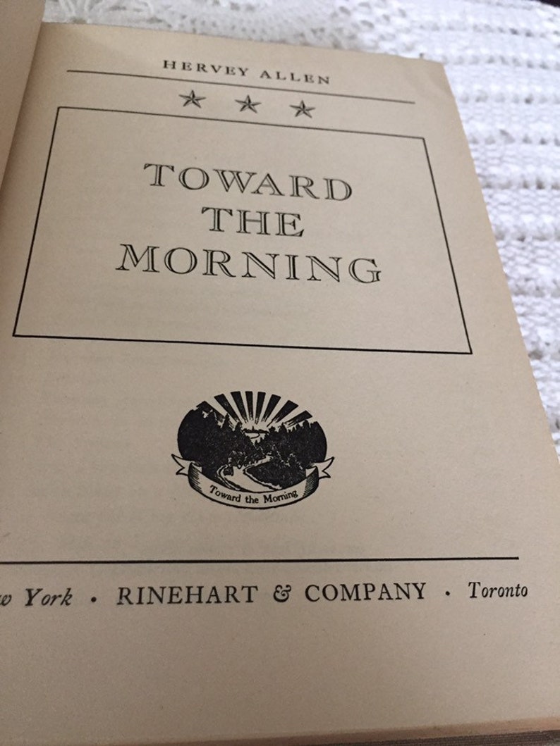 May include: A book cover with the title "Toward the Morning" by Hervey Allen. The cover features a black and white illustration of a sunrise over a mountain range.