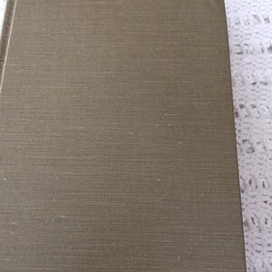 May include: A brown linen-textured book cover.