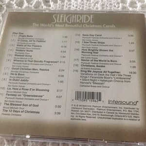 May include: A CD case with a beige background and a white label. The label has the title "Sleighride: The World's Most Beautiful Christmas Carols" and a list of Christmas songs with their corresponding track numbers and artists. The CD case also has a barcode and the Intersound logo.