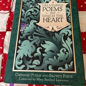 May include: A hardcover book titled "Treasured Poems that Touch the Heart" with a green cover and gold lettering. The cover features ornate teal and black floral designs and the text "Cherished Poems and Favorite Poets" and the name "Mary Sanford Laurence".