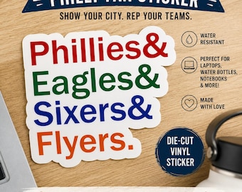 May include: A die-cut vinyl sticker featuring the text Phillies& in red, Eagles& in green, Sixers& in blue, and Flyers. in orange. The sticker includes additional text: PHILLY FAN STICKER, SHOW YOUR CITY. REP YOUR TEAMS., and FOUR TEAMS. ONE CITY. ALL HEART.