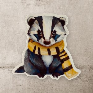 May include: A watercolor illustration of a badger wearing a yellow and black striped scarf. The badger is sitting on a white background.