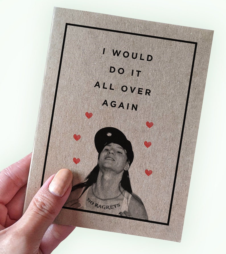 May include: A brown card with the text "I would do it all over again" and a black and white photo of a person with the text "No Ragrets" on a necklace. There are red hearts around the photo.