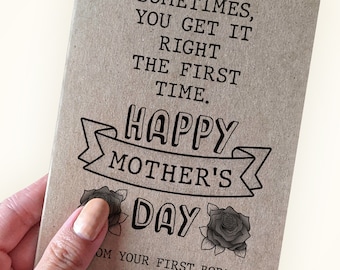 May include: A brown card with the text "Sometimes, you get it right the first time. Happy Mother's Day" and two black roses. The text "From your first born" is at the bottom of the card.