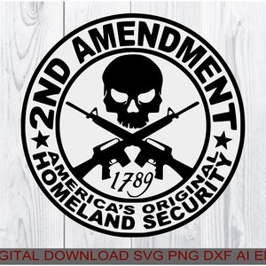 May include: Black and white graphic design of a skull with crossed rifles. The design is in a circle with the text "2nd Amendment America's Original Homeland Security 1789" around the outside.
