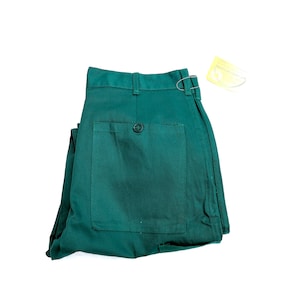 May include: A pair of dark green pants folded in half, showing the back pocket and a single button. The pants have a straight leg and a relaxed fit.