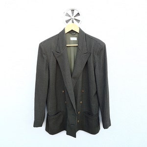May include: A double-breasted blazer in a black and green checkered pattern. The blazer has a classic fit and features a double row of buttons down the front.