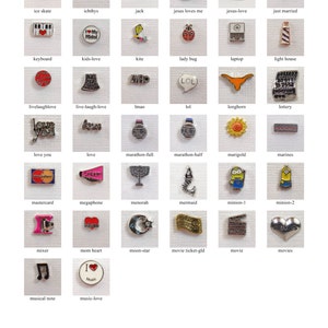 May include: A collection of 36 silver charm beads with various designs and colors. The charms include a variety of themes, such as religious, holiday, and everyday life. The charms are all approximately 1 inch in diameter.