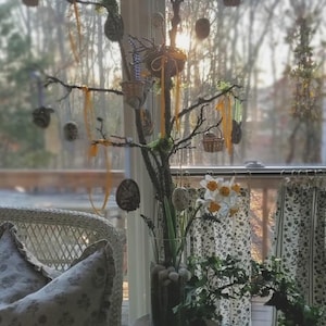 May include: A handmade wooden sign with the text "Welcome" in a handwritten style. The sign is painted white with a distressed finish and features a decorative floral design in shades of pink and green. It is designed for indoor or outdoor use.