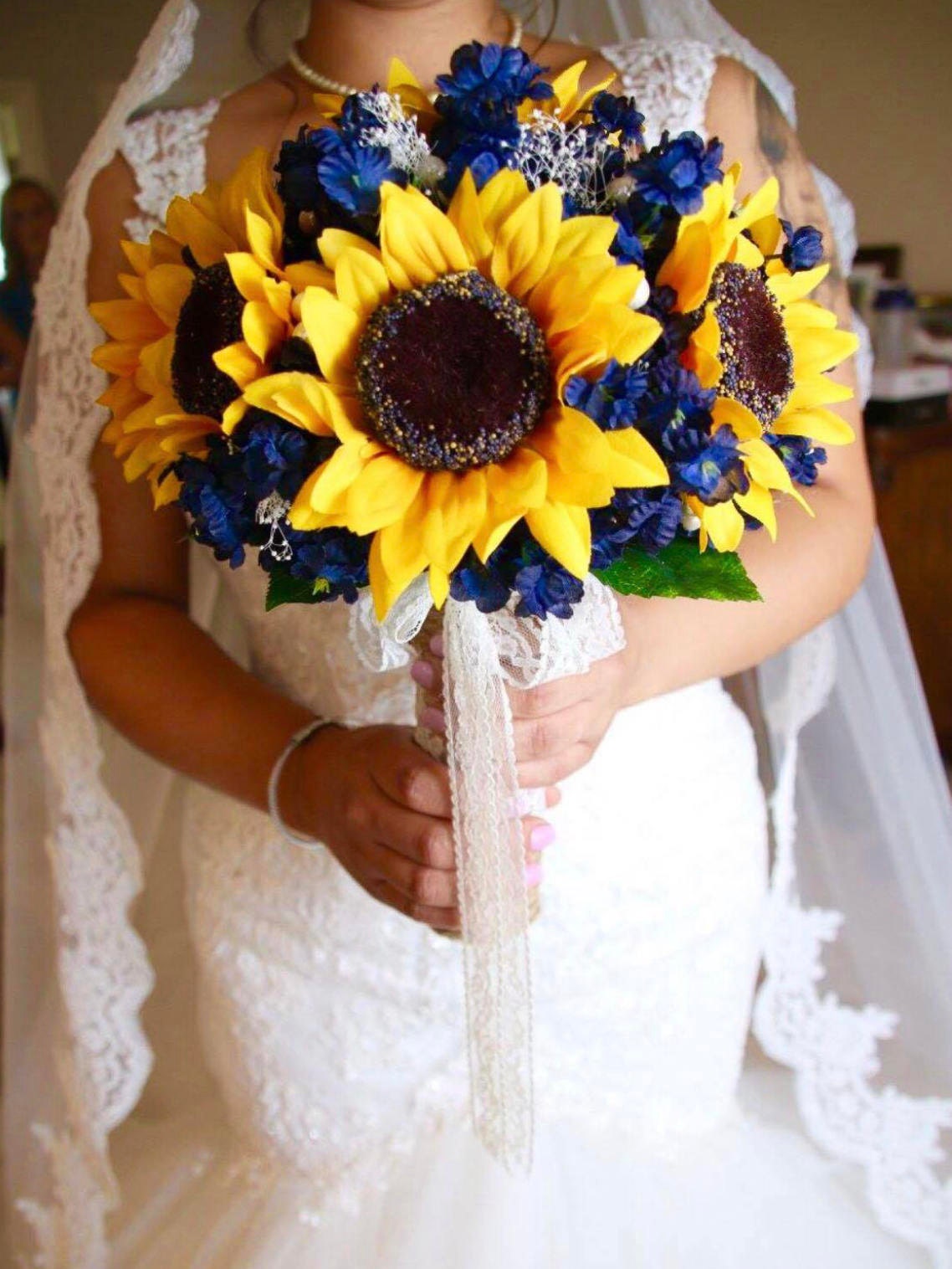 navy bridesmaid dresses with sunflower bouquets Plum, wisteria, lilac and sunflowers come together to create this beauty for a lovely bride! We custom matched her flowers to her bridesmaids dresses and added pops of white and navy to