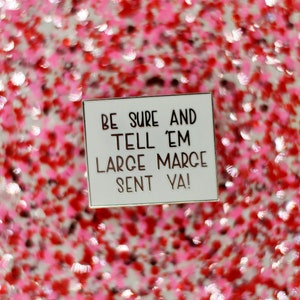May include: White enamel pin with a gold border. The pin says "Be sure and tell 'em Large Marge sent ya!"
