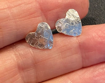 Sterling silver textured handmade heart earrings.