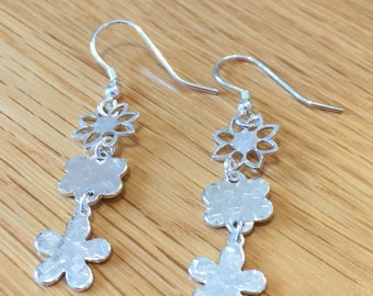 Large solid silver triple dangle flower earrings.