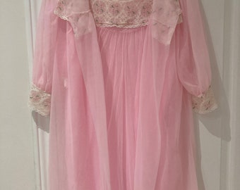 May include: A pink sheer nightgown with a matching robe. Both pieces feature delicate lace trim and floral embroidery.