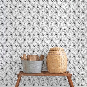 May include: A white wall with a black and white geometric pattern wallpaper. A wooden bench with a wicker basket and a metal bucket with wood logs on top of it. Two pairs of black shoes are on the white floor.